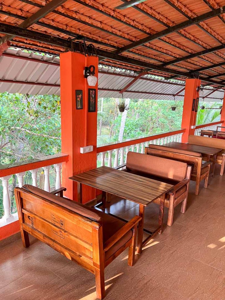 Photo of rectangular Seating tables in the restaurant of Bonds Hostel Candolim Goa