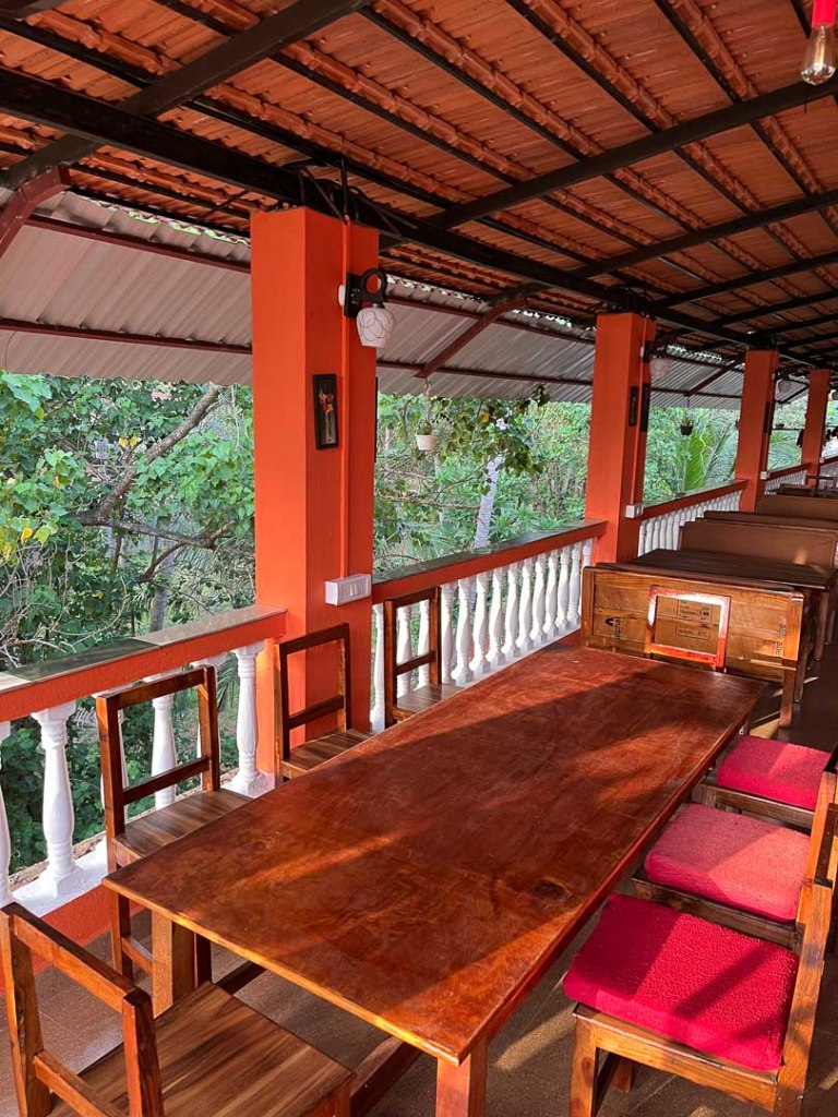 Photo of rectangular Seating tables in the restaurant of Bonds Hostel Candolim Goa
