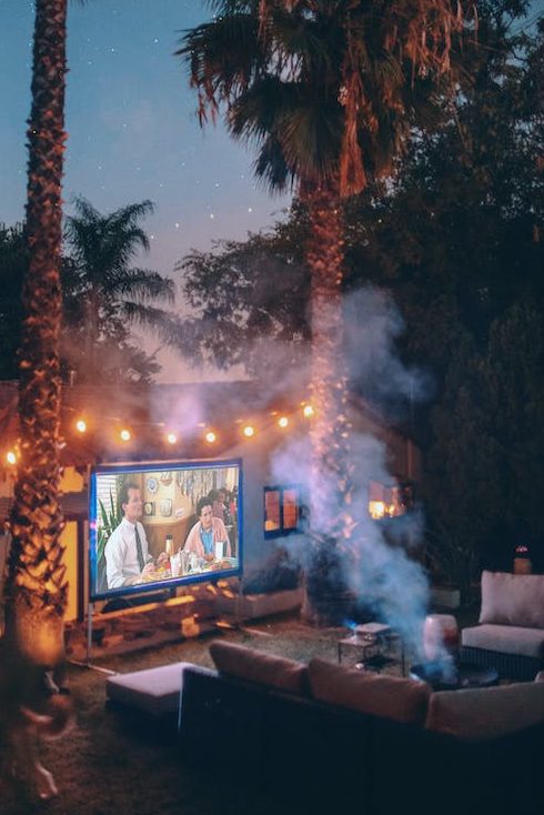 palm trees near projection screen during nighttime